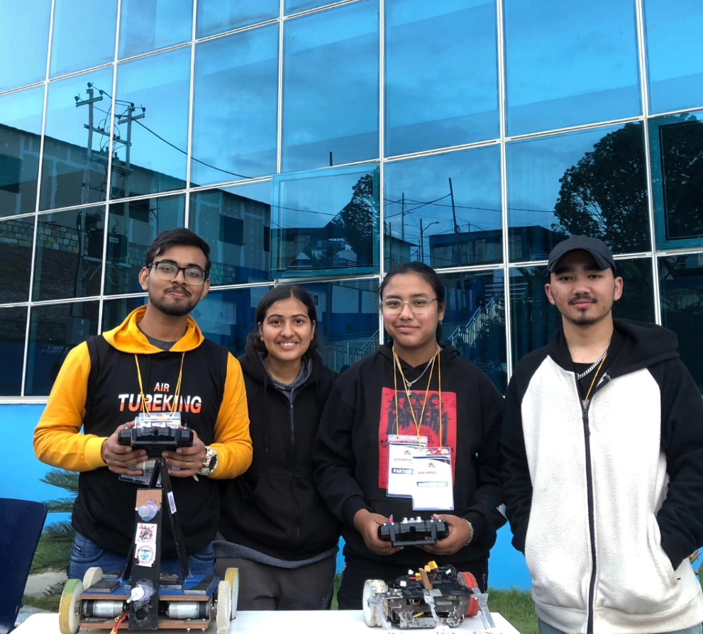 RoboYuwa youth robotics members showcasing custom built robots at competition